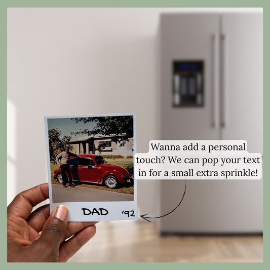 Hand holding a retro Polaroid-style custom photo magnet labeled "Dad 1992" in front of a modern refrigerator, with text bubble offering personalized caption add-on for an extra fee.